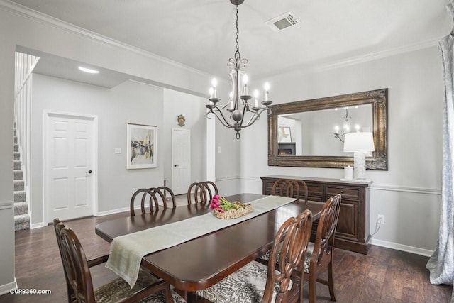 dining area with a chandelier, crown molding, dark wood-style floors, and visible vents