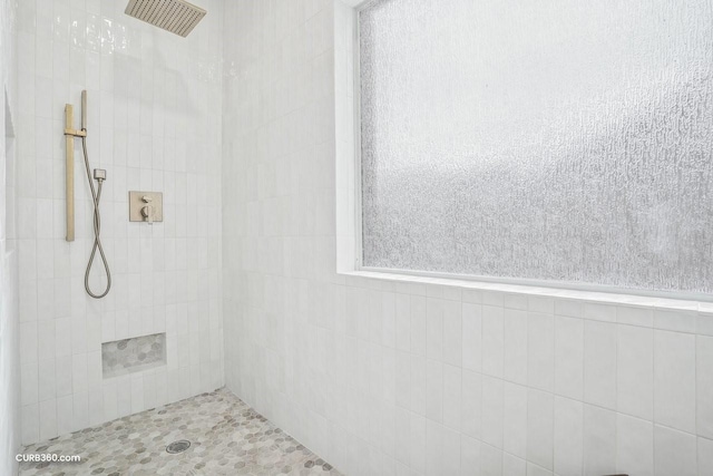 full bath with a tile shower