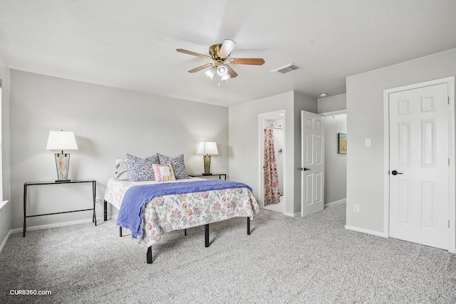 carpeted bedroom with baseboards, a ceiling fan, visible vents, and ensuite bath