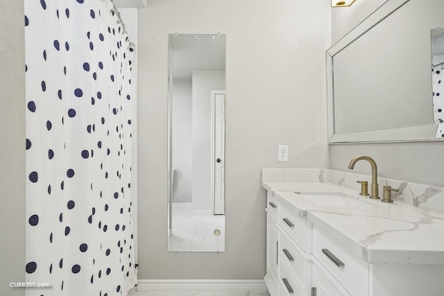 full bath featuring vanity, baseboards, and curtained shower