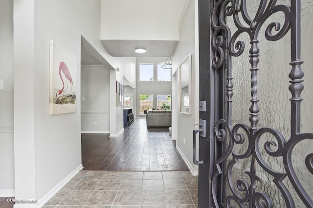 entrance foyer featuring baseboards and a high ceiling