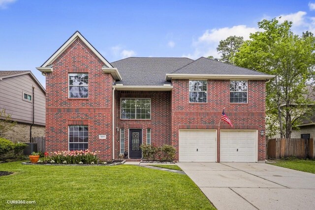 traditional home with brick siding, a front lawn, fence, and concrete driveway