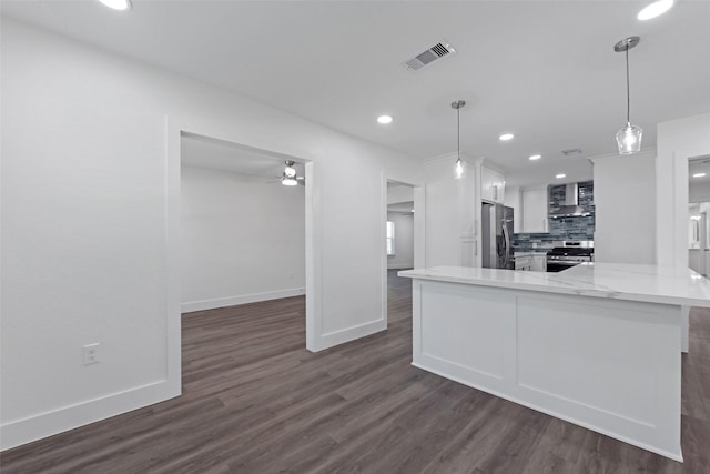 4074 Cheena Dr, Houston, TX 77025 - kitchen featuring appliances with stainless steel finishes, white cabinetry, baseboards, dark wood-style flooring, and tasteful backsplash