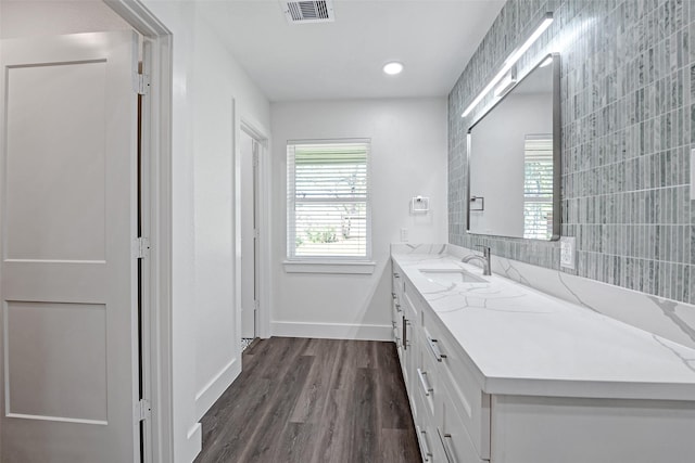 4074 Cheena Dr, Houston, TX 77025 - bathroom featuring baseboards, vanity, wood finished floors, and recessed lighting