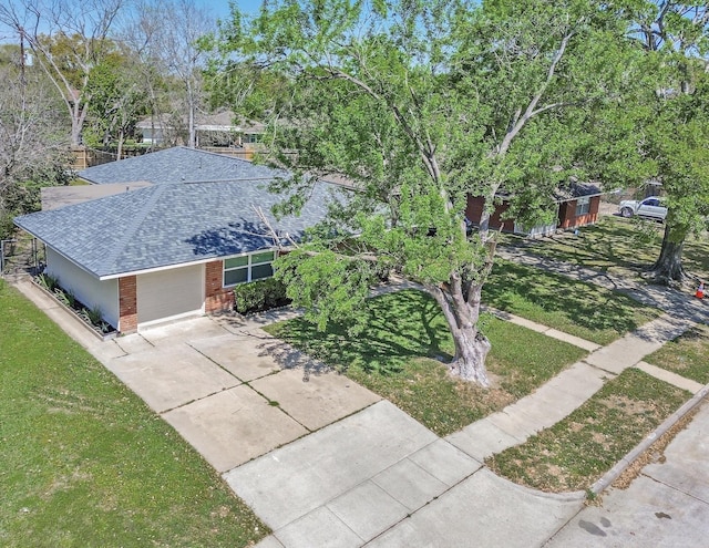 4074 Cheena Dr, Houston, TX 77025 - view of front of house featuring a shingled roof, brick siding, a front yard, and concrete driveway