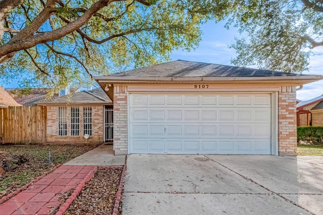 single story home featuring roof with shingles, fence, driveway, brick siding, and a garage