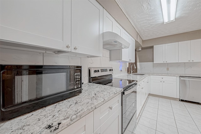 kitchen with a textured ceiling, white cabinets, stainless steel appliances, under cabinet range hood, and a sink