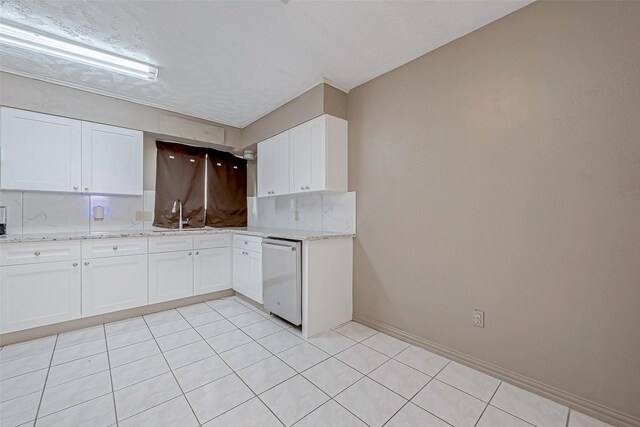 kitchen featuring dishwasher, white cabinets, a sink, and light stone counters