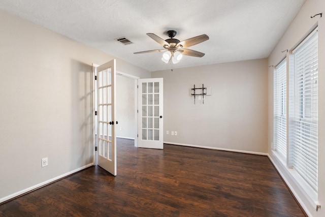spare room with visible vents, baseboards, ceiling fan, wood finished floors, and french doors