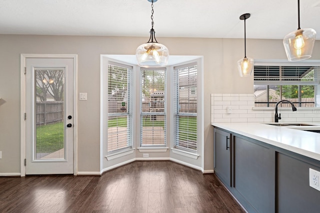 interior space featuring dark wood-style flooring, light countertops, a wealth of natural light, gray cabinetry, and a sink