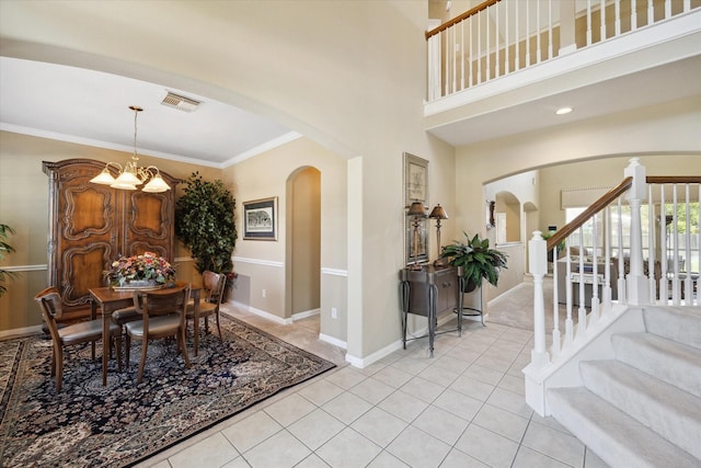 1314 Cross Valley Dr, Sugar Land, TX 77479 - dining room with arched walkways, light tile patterned flooring, stairs, a chandelier, and crown molding