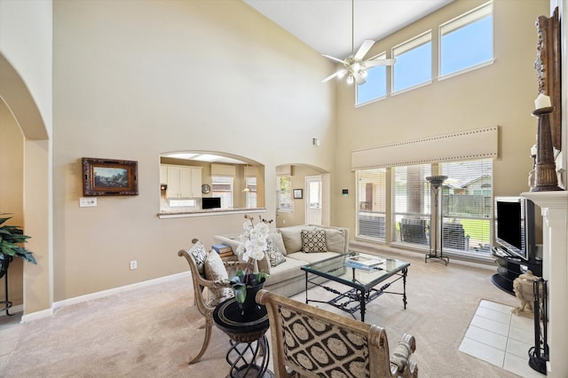 1314 Cross Valley Dr, Sugar Land, TX 77479 - living area featuring light carpet, ceiling fan, high vaulted ceiling, arched walkways, and baseboards