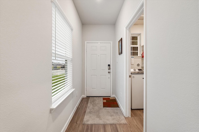 800 Westpointe Dr, Dayton, TX 77535 - entryway featuring baseboards, wood finished floors, and washer / dryer