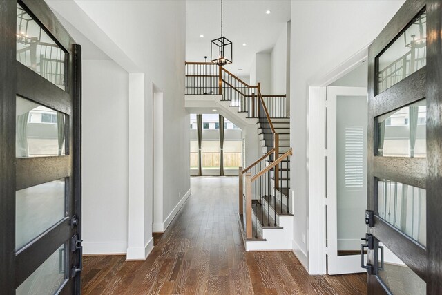 626 Attingham Dr, Houston, TX 77024 - entrance foyer with stairs, wood finished floors, a chandelier, baseboards, and a high ceiling