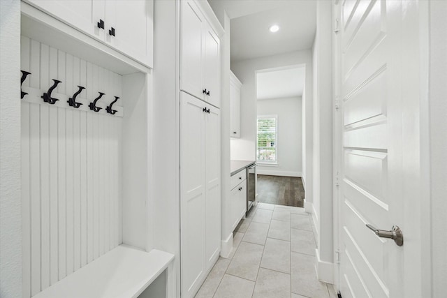 mudroom with baseboards, light tile patterned flooring, and recessed lighting