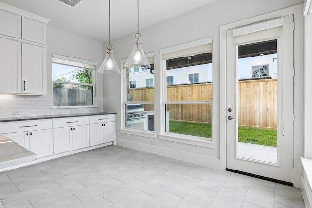unfurnished dining area featuring visible vents