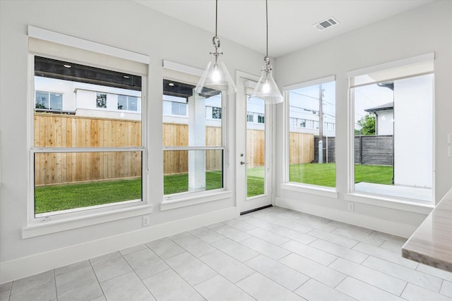 unfurnished sunroom featuring visible vents