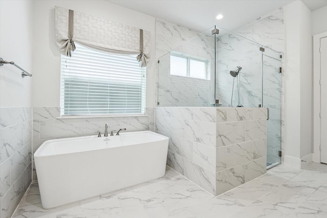 full bath with a freestanding bath, marble finish floor, and a marble finish shower