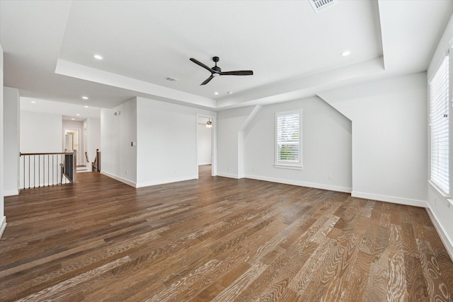 interior space with recessed lighting, dark wood finished floors, a tray ceiling, baseboards, and ceiling fan
