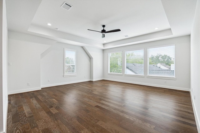 additional living space featuring visible vents, a wealth of natural light, ceiling fan, and dark wood-style flooring