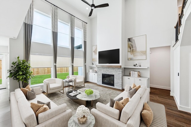 626 Attingham Dr, Houston, TX 77024 - living area with a high ceiling, plenty of natural light, a stone fireplace, wood finished floors, and ceiling fan