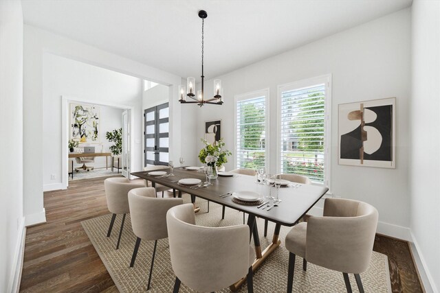 626 Attingham Dr, Houston, TX 77024 - dining area featuring baseboards, dark wood finished floors, and a chandelier