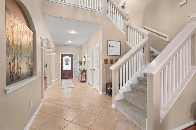 9330 Vander Rock Dr, Houston, TX 77095 - foyer with tile patterned flooring, stairs, and baseboards
