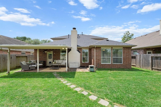 9330 Vander Rock Dr, Houston, TX 77095 - back of property with a lawn, an outdoor living space, a fenced backyard, and brick siding