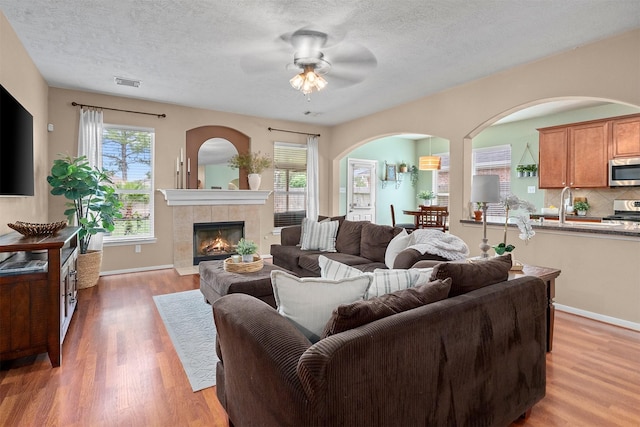 9330 Vander Rock Dr, Houston, TX 77095 - living area featuring a wealth of natural light, visible vents, arched walkways, and ceiling fan