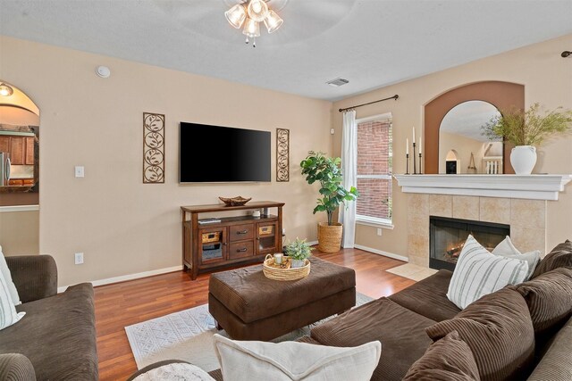 9330 Vander Rock Dr, Houston, TX 77095 - living area featuring visible vents, wood finished floors, ceiling fan, and arched walkways
