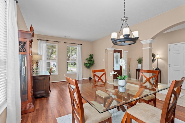 9330 Vander Rock Dr, Houston, TX 77095 - dining area with a chandelier, baseboards, arched walkways, and wood finished floors