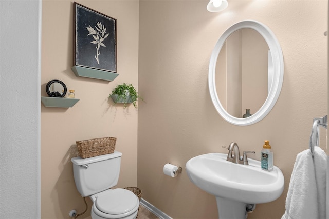9330 Vander Rock Dr, Houston, TX 77095 - bathroom with toilet, a sink, and baseboards