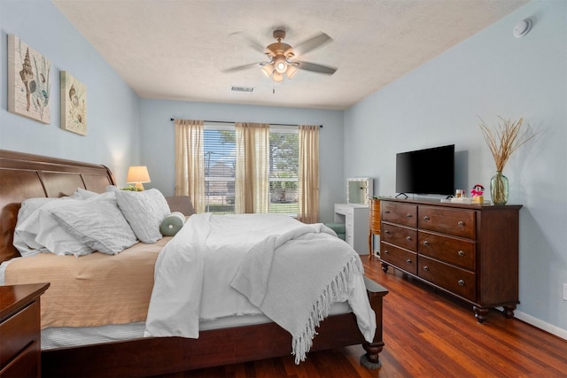 9330 Vander Rock Dr, Houston, TX 77095 - bedroom featuring baseboards, visible vents, a ceiling fan, and dark wood-style flooring