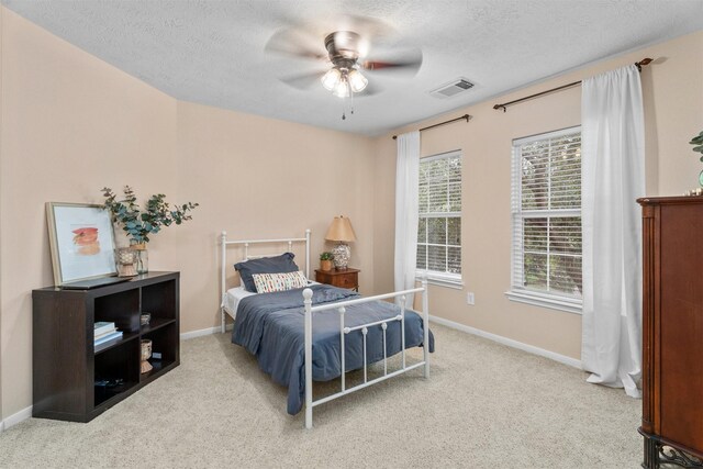 9330 Vander Rock Dr, Houston, TX 77095 - carpeted bedroom featuring a textured ceiling, visible vents, and baseboards