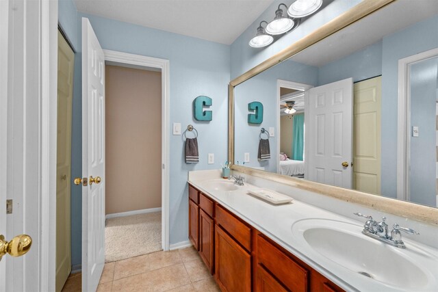 9330 Vander Rock Dr, Houston, TX 77095 - ensuite bathroom featuring tile patterned flooring, double vanity, a sink, and baseboards