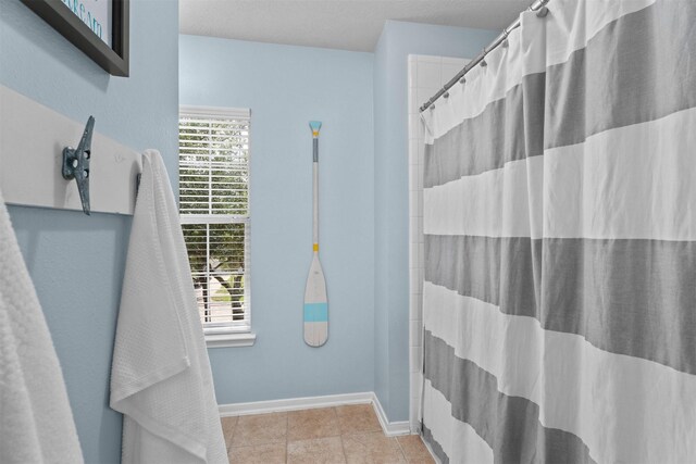 9330 Vander Rock Dr, Houston, TX 77095 - full bath featuring baseboards, curtained shower, tile patterned floors, and a wealth of natural light