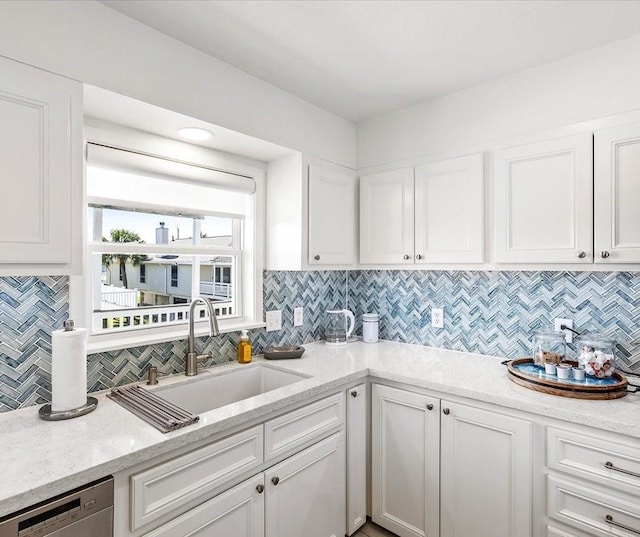 16701 Cormorant Rd, Jamaica Beach, TX 77554 - kitchen with a sink, dishwasher, white cabinetry, and backsplash