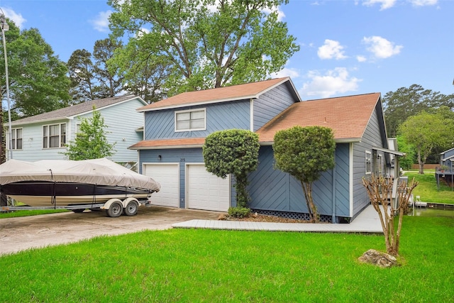 215 Clear Water St E, Montgomery, TX 77356 - view of front of home with a garage, a front yard, and driveway