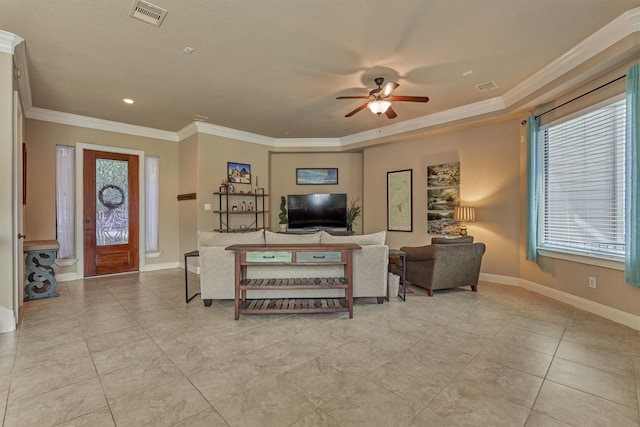343 Old Aqua Lndg E, Conroe, TX 77356 - living area featuring crown molding, baseboards, visible vents, and a ceiling fan