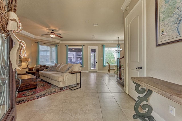 343 Old Aqua Lndg E, Conroe, TX 77356 - living area featuring light tile patterned flooring, ornamental molding, baseboards, and ceiling fan with notable chandelier
