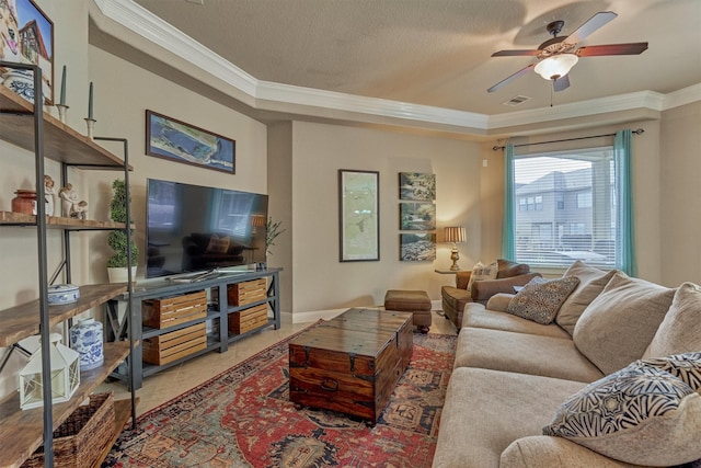 343 Old Aqua Lndg E, Conroe, TX 77356 - living room with a ceiling fan, a textured ceiling, baseboards, visible vents, and ornamental molding