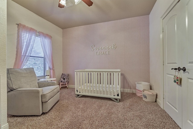 343 Old Aqua Lndg E, Conroe, TX 77356 - carpeted bedroom with baseboards, ceiling fan, and a nursery area