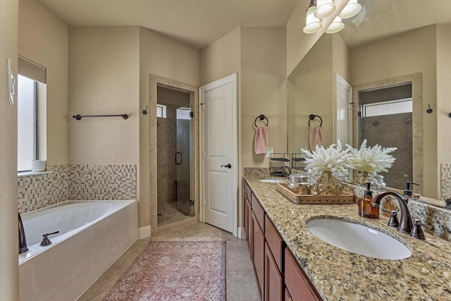 343 Old Aqua Lndg E, Conroe, TX 77356 - full bathroom featuring a shower stall, tile patterned floors, a sink, a garden tub, and double vanity