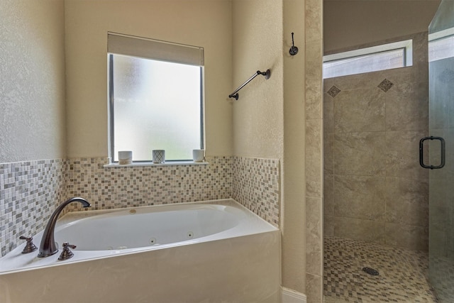 343 Old Aqua Lndg E, Conroe, TX 77356 - bathroom with a textured wall, a jetted tub, and a shower stall