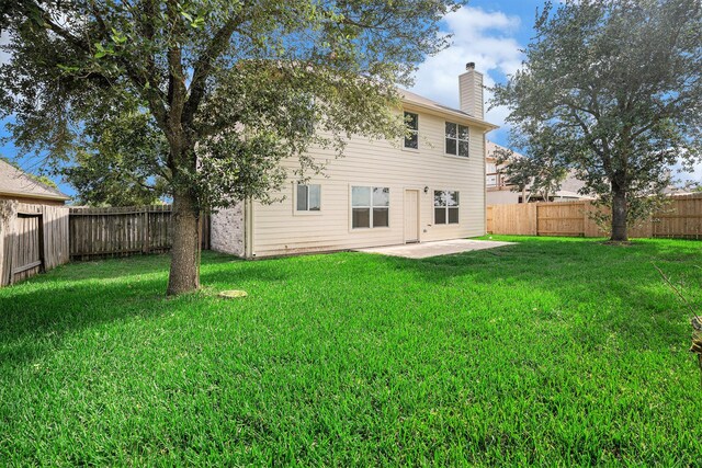 2522 Barton Springs St, League City, TX 77573 - rear view of house featuring a chimney and a patio