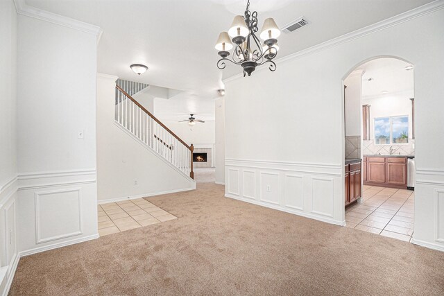 2522 Barton Springs St, League City, TX 77573 - spare room featuring light carpet, arched walkways, stairs, a sink, and ceiling fan