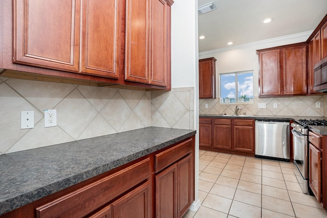 2522 Barton Springs St, League City, TX 77573 - kitchen featuring appliances with stainless steel finishes, a sink, crown molding, dark countertops, and tasteful backsplash