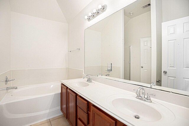 2522 Barton Springs St, League City, TX 77573 - full bath with vaulted ceiling, a garden tub, tile patterned floors, and double vanity