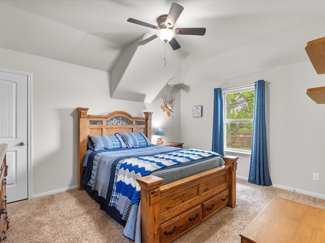 bedroom with a ceiling fan, vaulted ceiling, baseboards, and light colored carpet