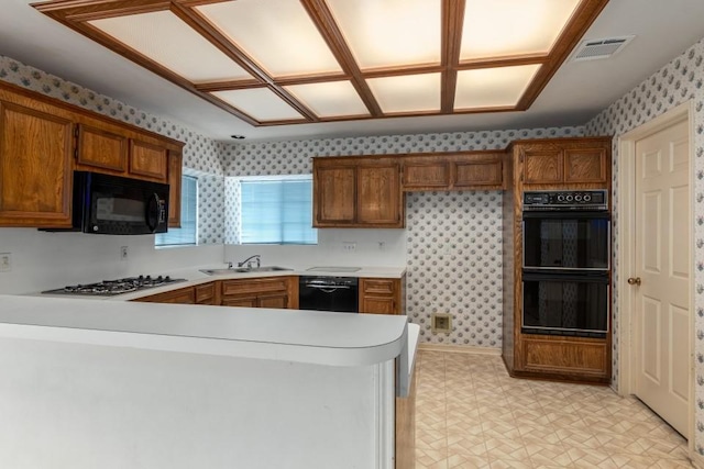 16918 Ascot Meadow Dr, Sugar Land, TX 77479 - kitchen featuring a peninsula, visible vents, black appliances, a sink, and wallpapered walls